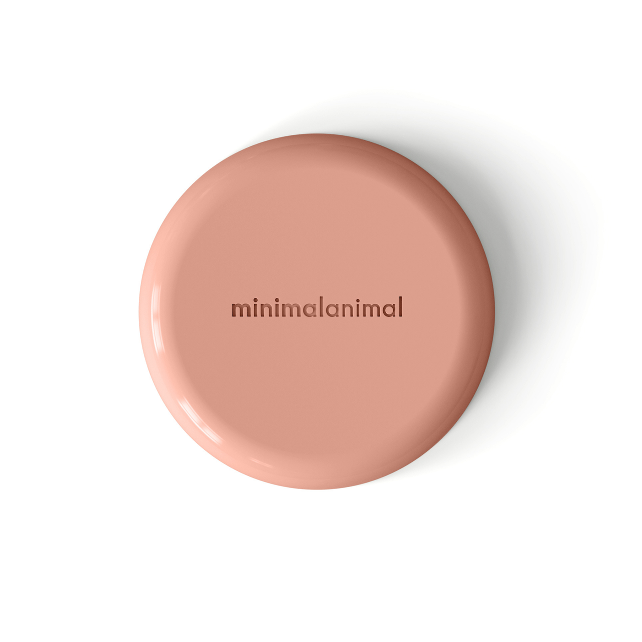 Circular modern coral pink silicone lick mat designed for use with ceramic bowl for dogs and cats