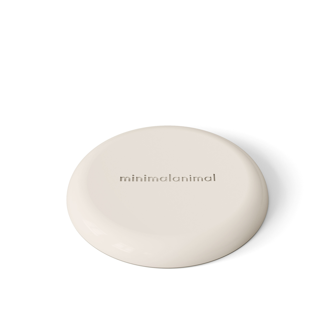 Circular modern tan silicone lick mat designed for use with ceramic bowl for dogs and cats