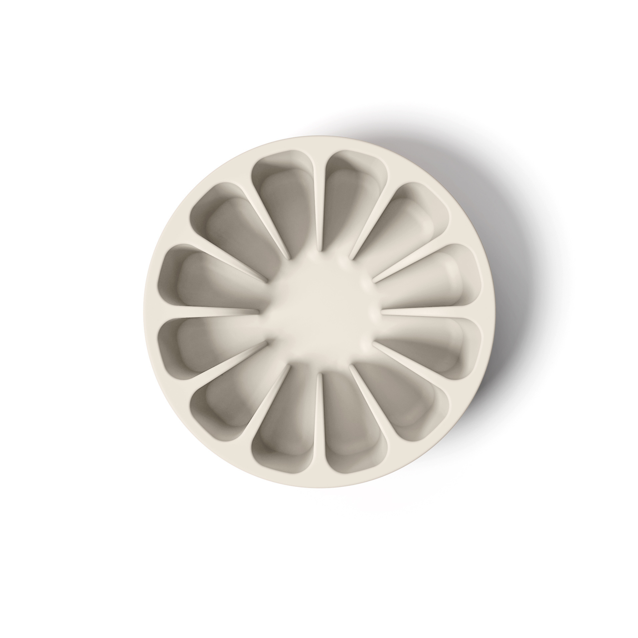 Light tan minimalist circular silicone slow feeder designed to resemble grapefruit for dog use